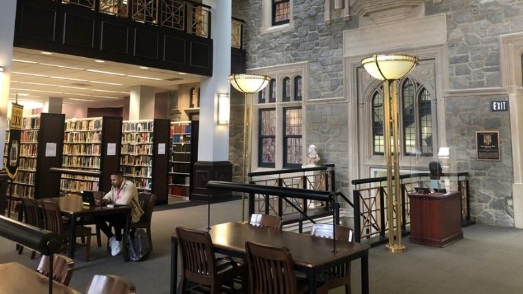 Student on computer inside library