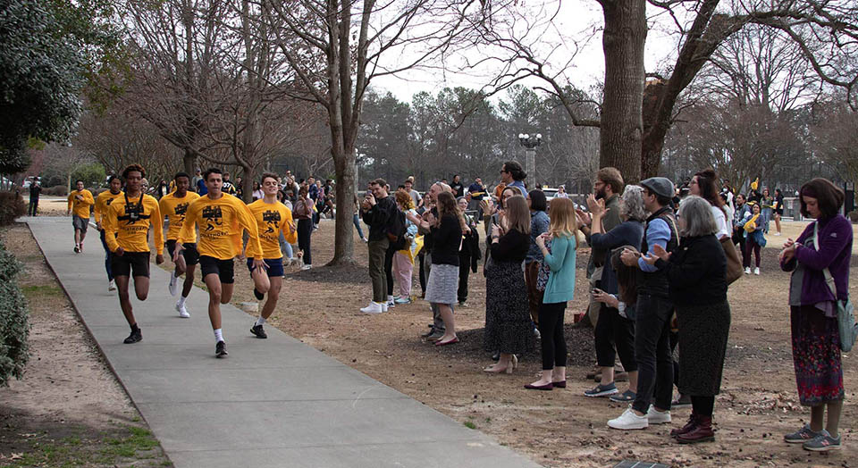 Oglethorpe Day 2023 runners race around the quad while spectators cheer.