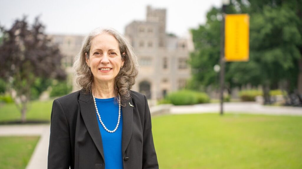 Interim President Dr. Kathryn McClymond stands on the quad in front of Lowry Hall.