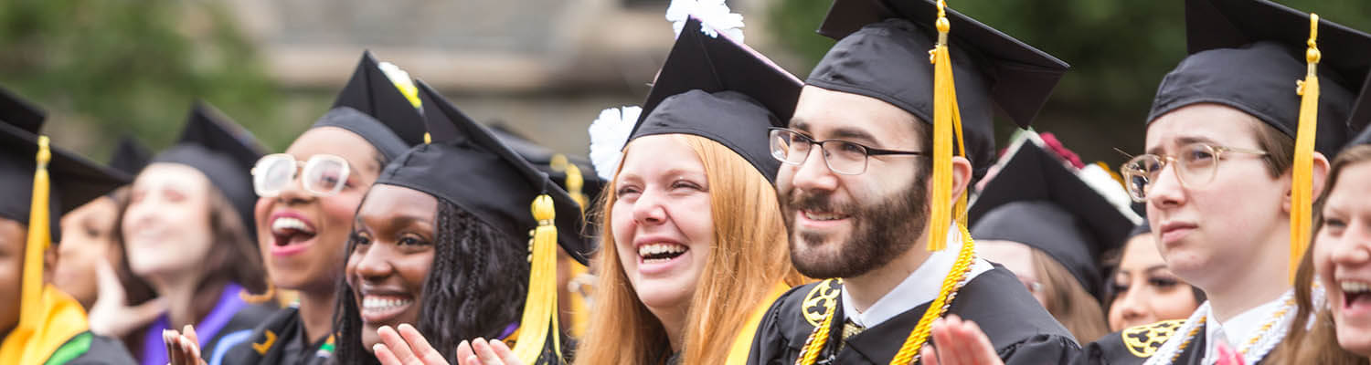 Graduates smiling at commencement 2023