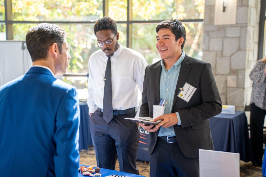 A student speaks with a recruiter at the fall Career and Grad Fair
