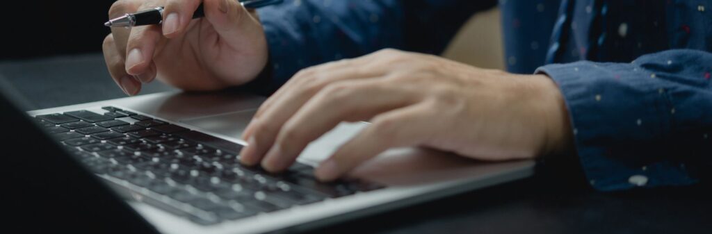 hands typing on a keyboard