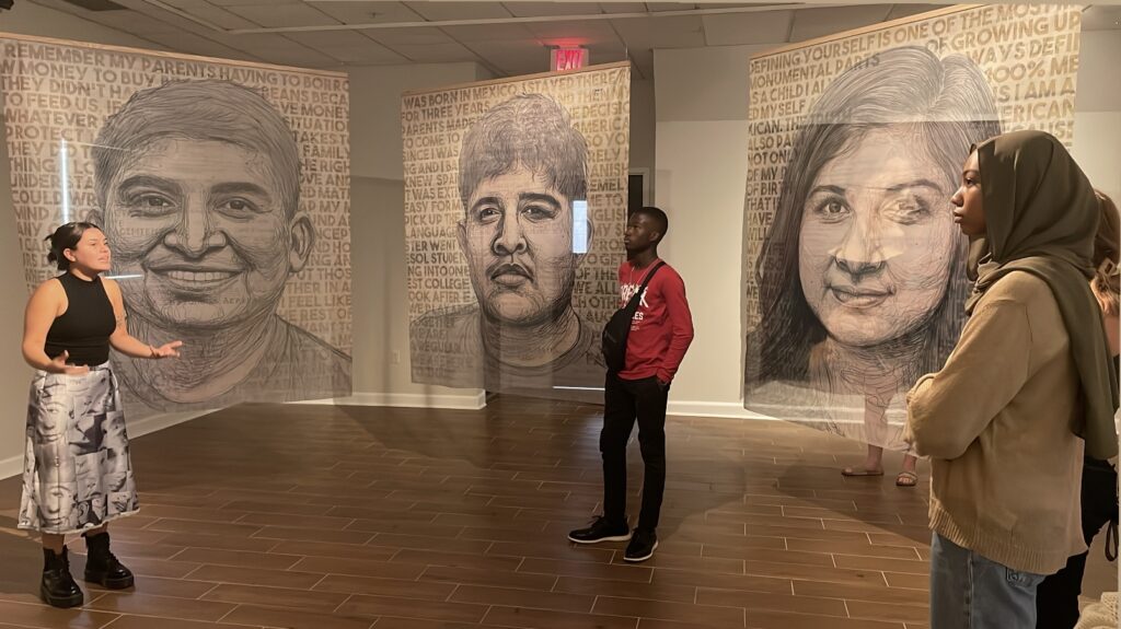 Sophia Sobrino giving a tour in the Oglethorpe Museum of Art in Yehimi Cambron's exhibition.