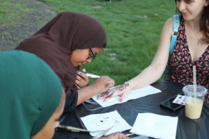 Student receiving a Henna tattoo at the World Showcase