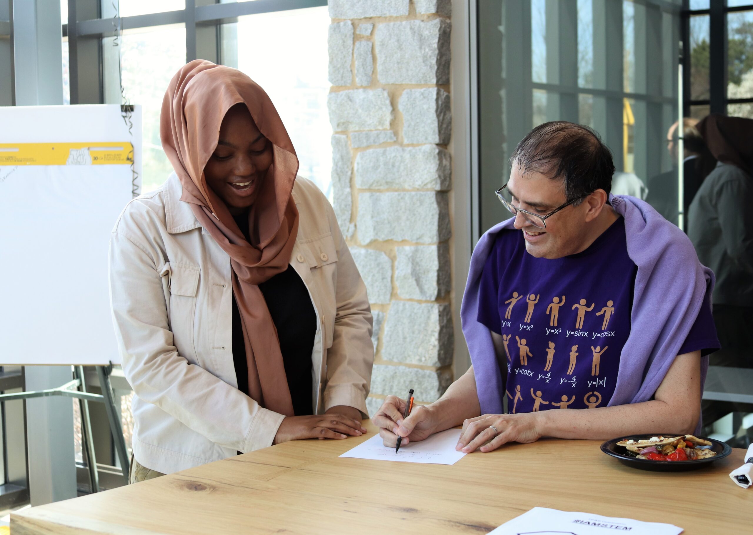 A student and Oglethorpe professor Dr. John Nardo chat and smile