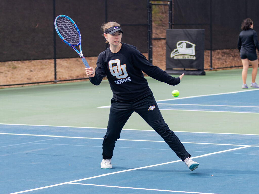 Izzy Forster playing tennis at Oglethorpe's Downing Howell Tennis Court.