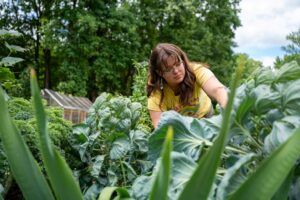 Oglethorpe student Heidi Ullman tends to plants in Petey's Garden