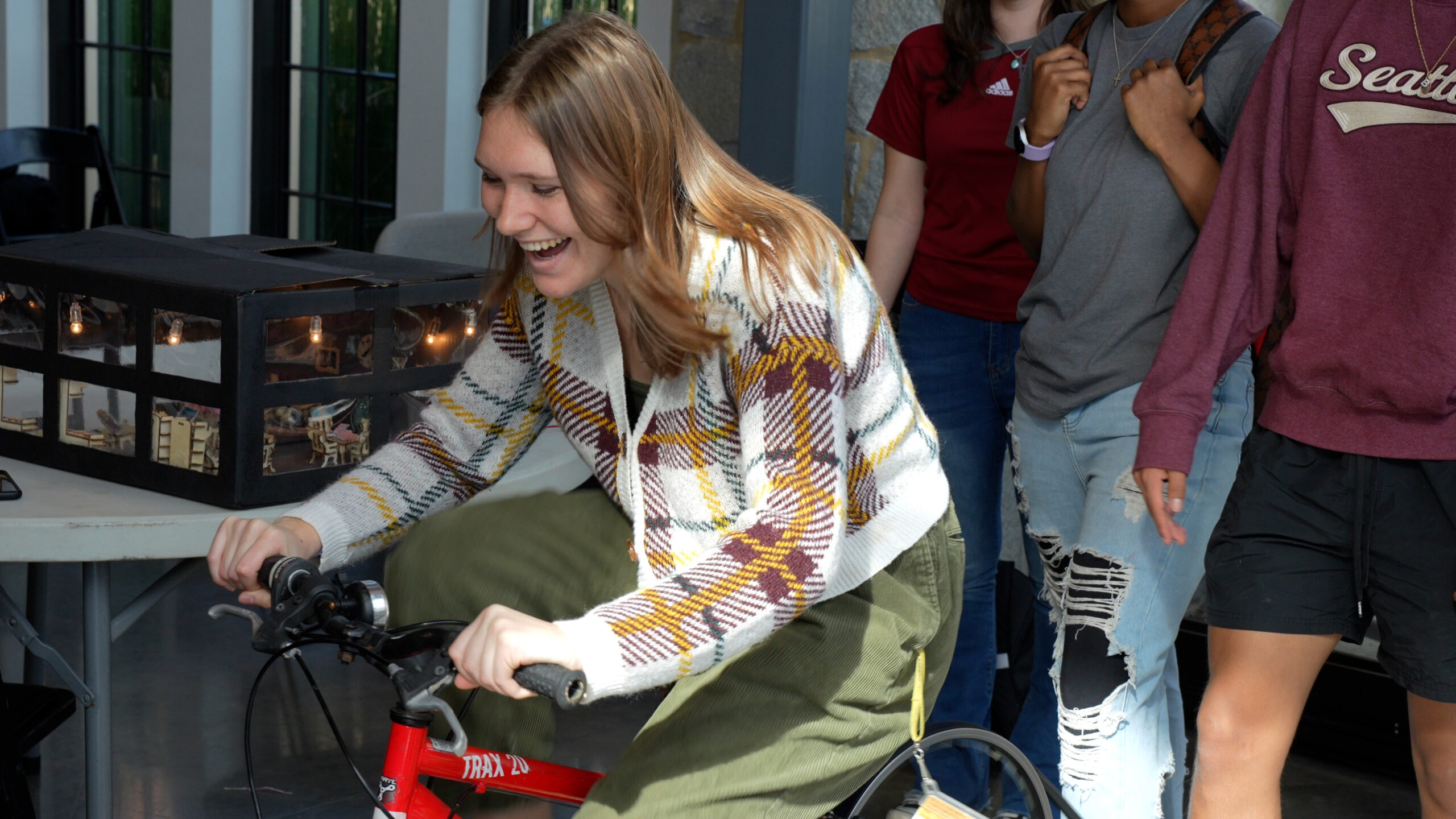 A student pedals a bicycle-powered generator