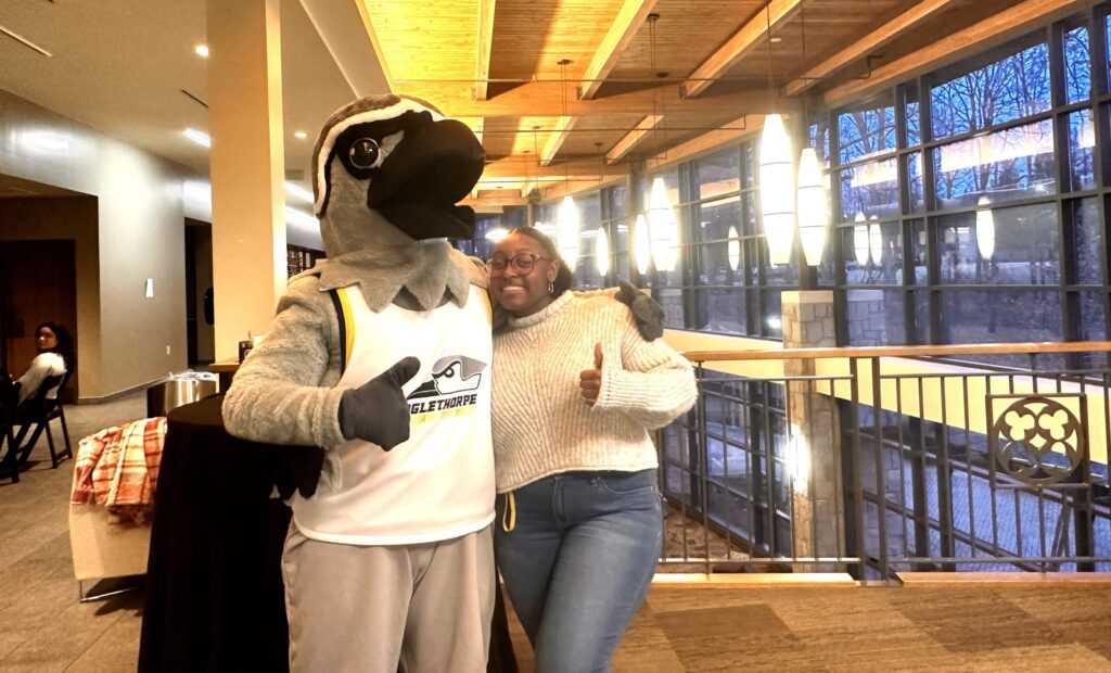 Mascot Petey and Senior Class President Randi Parks in the campus center.