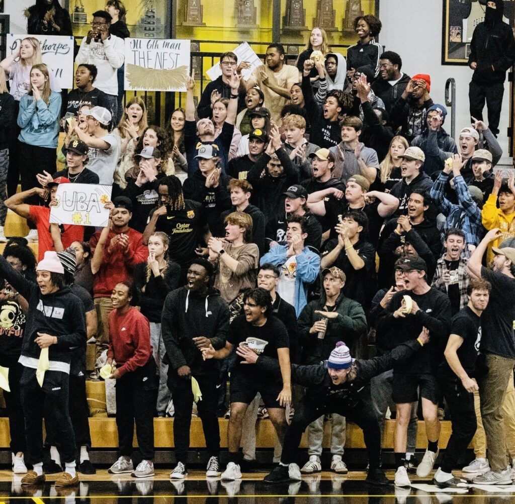 A crowded and lively student section at an Oglethorpe University basketball game