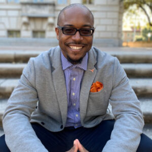 Dr. Brandon Jones sitting on steps