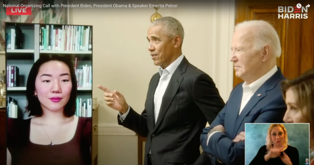 President Obama standing next to President Biden and Speaker Pelosi while speaking to Ashleigh Ewald over a video call.