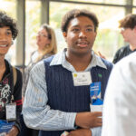 Diverse students speak with a recruiter at the career fair 2024.