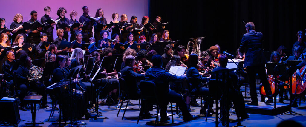 Oglethorpe orchestra and Singers perform on stage in Conant 2023.