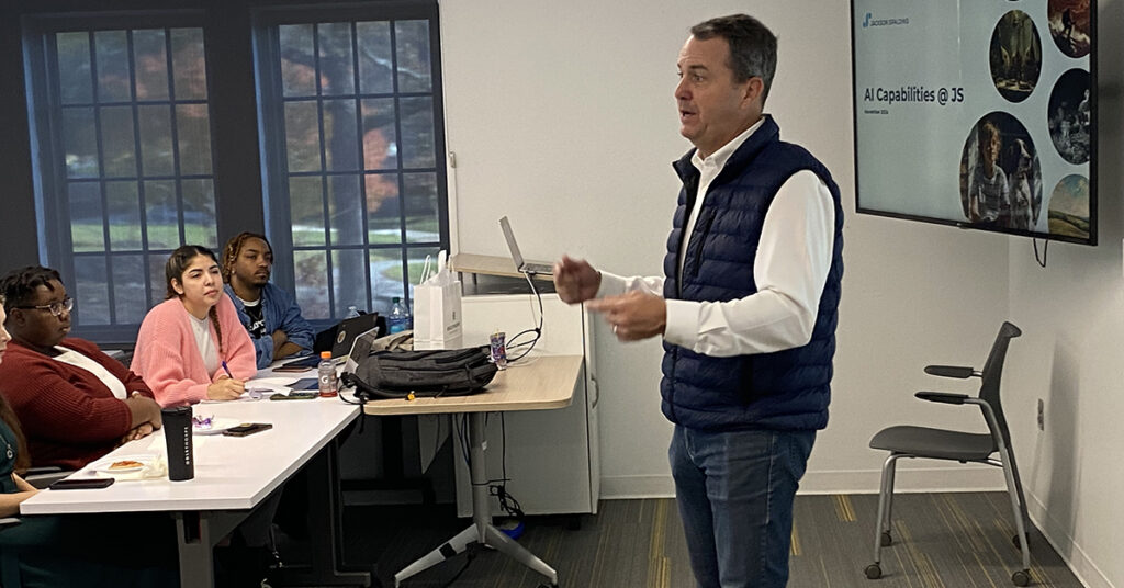 Man standing in front of class teaching class