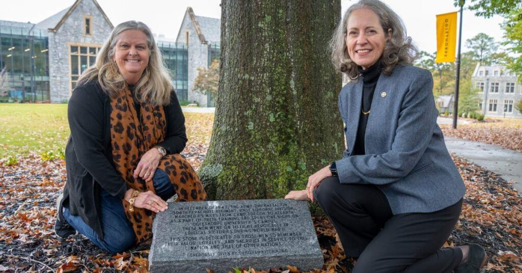 Dr. Kathryn McClymond and Deborah Kitchin '80 with the marker recognizing Easy Company