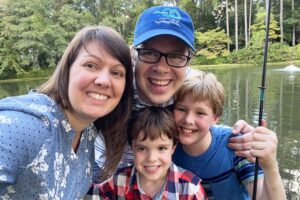 A family of four by a lake