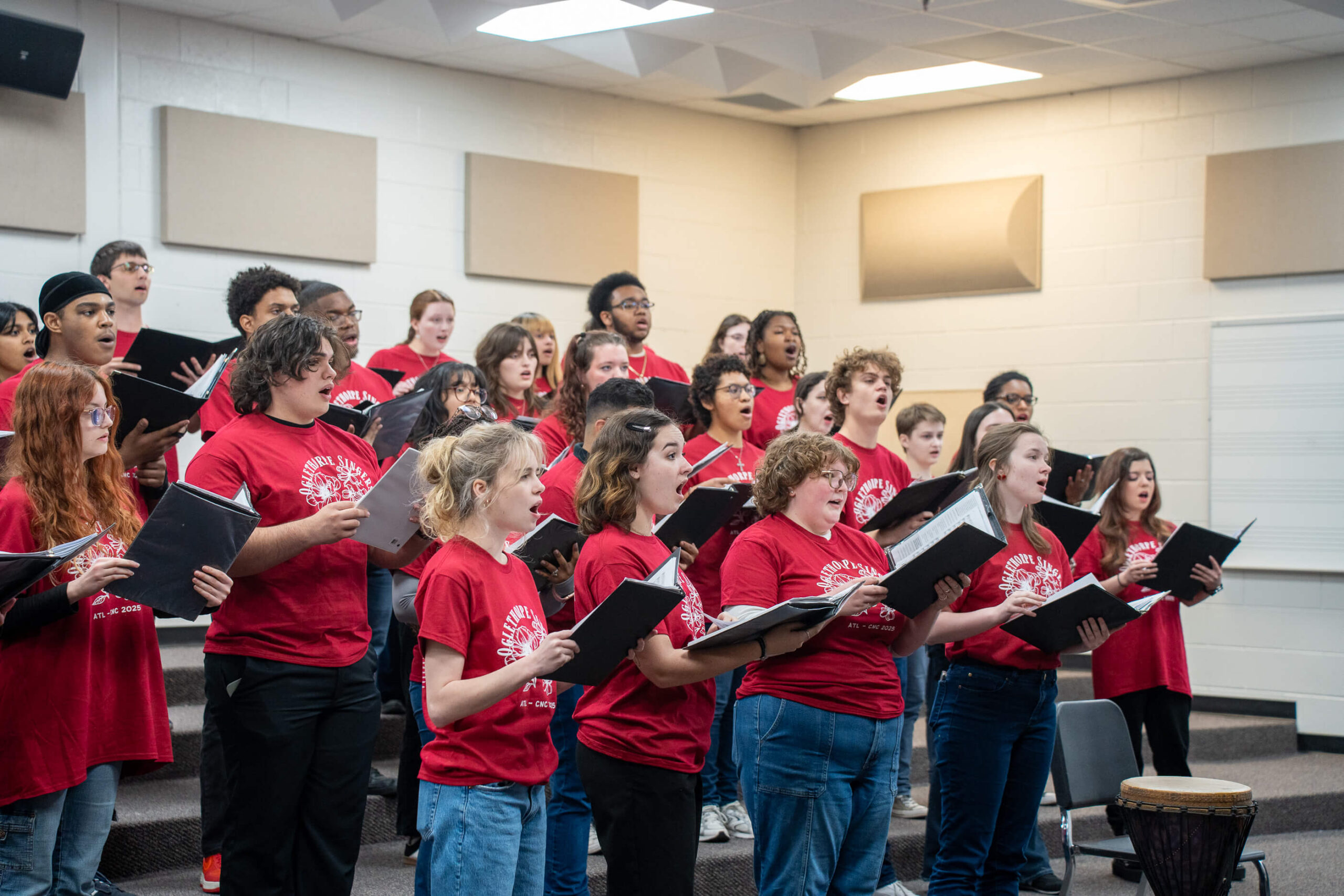 The Oglethorpe University Singers rehearse in a practice room.