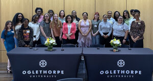 A group of female college students and faculty and staff leaders in a group picture