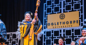 Dr. McClymond lifts the wooden mace during her inauguration ceremony in September 2024.