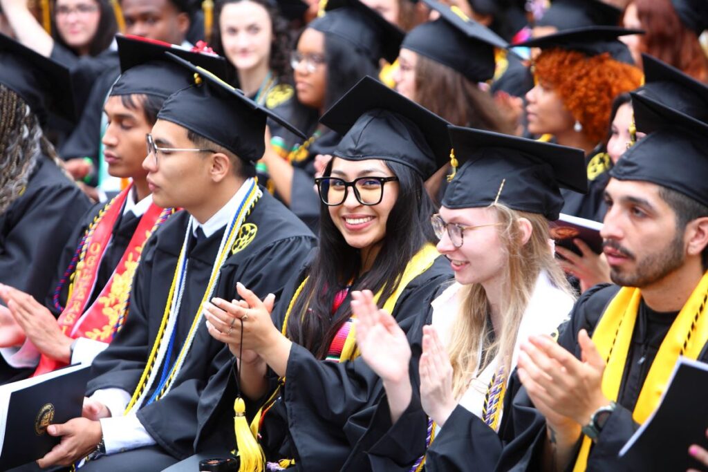 Graduates smile during the ceremony.