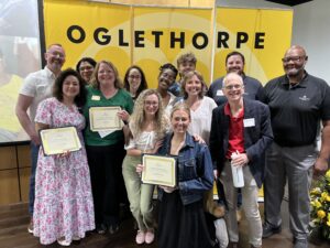 Faculty and staff award recipients pose for a group photo with their certificates.