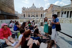 A man speaks to a group of students.
