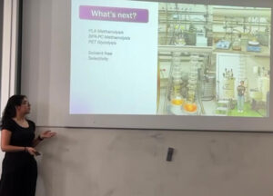 Emily Menéndez mid presentation reading a slide on her research.