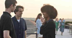 A group of men talk outside