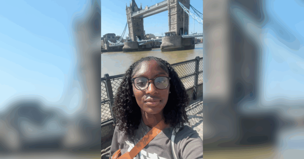 Student takes a photo in front of Tower Bridge in London.