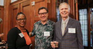 Alumni and Dr. Jay Lutz socialize at an alumni networking event.