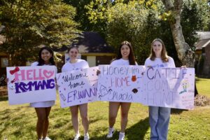 Panhellenic members hold signs for bid day
