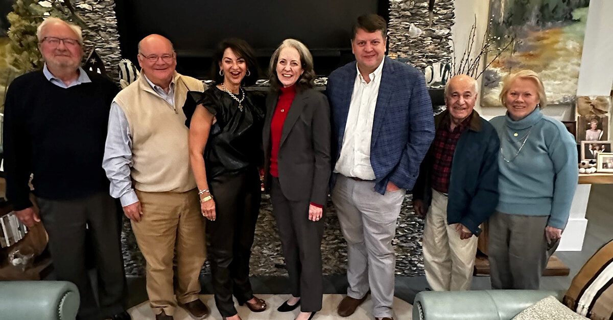 President MyClymond stands with Oglethorpe University alumni and supporters.