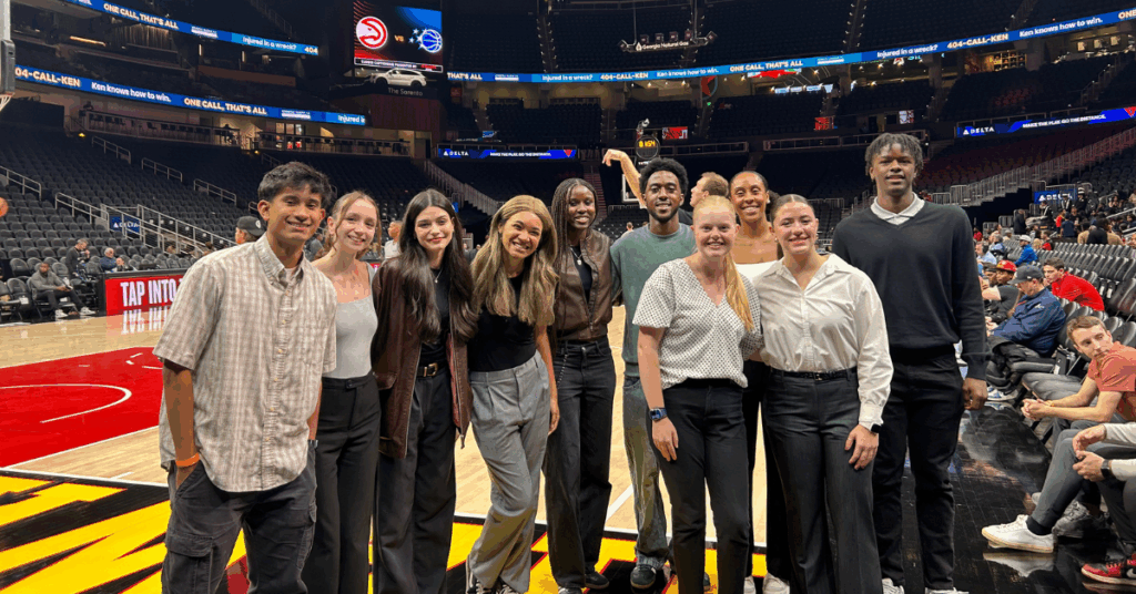 Students on Atlanta Hawks basketball court during shoot around.