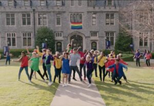 Still of "Love, Simon" cast performing a dance sequence in front of Lowry Hall.