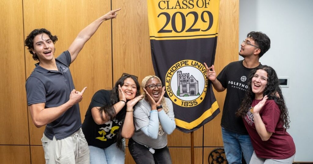 Students pose in front of a gonfalon that reads "Oglethorpe University Class of 2029"
