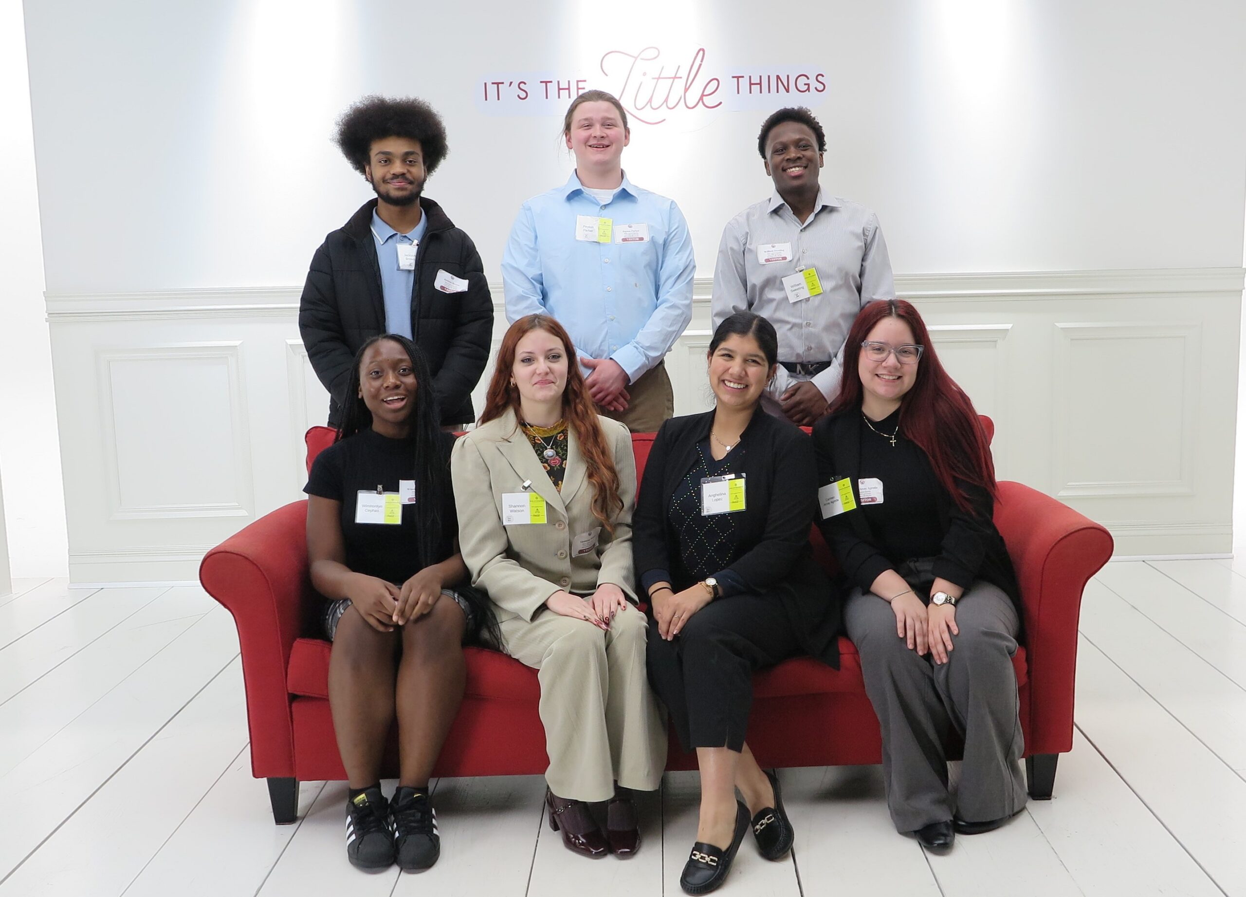 Students sit on a red couch used for Chick-fil-A commercials.