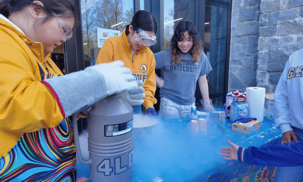 Students use nitrogen to make ice cream for a kid at the Atlanta Science Festival.