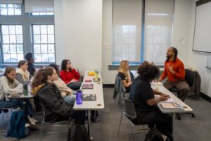 A teacher speaks with students in class