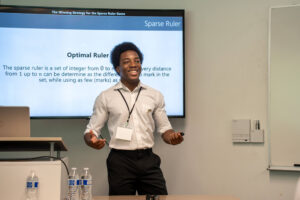 Adir Ali Yerima wears business casual attire presenting at LASS.