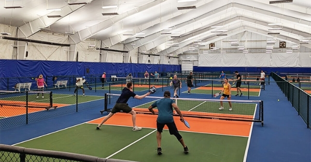 Teams play on multiple pickleball courts at Dill Dinkers Pickleball.