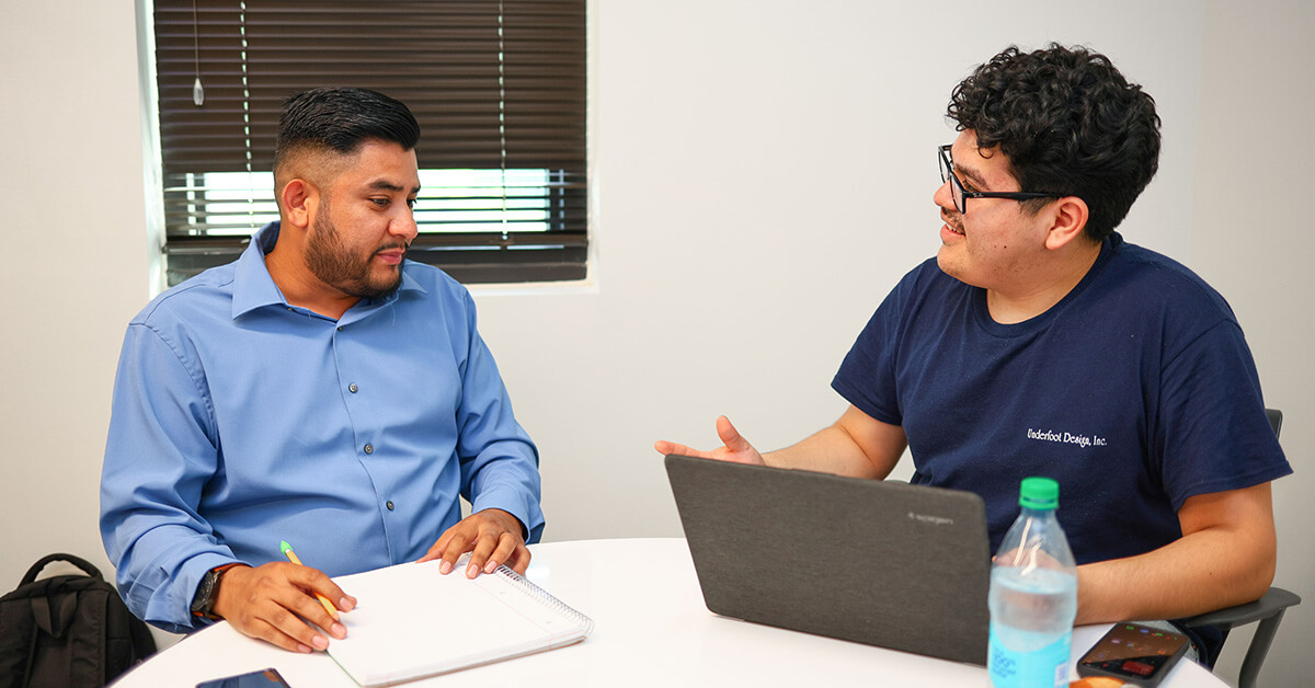 A counselor explaining college ROI outcomes and career pathways to a student.