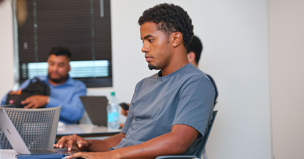 A student reviewing college ROI costs and financial aid options on a laptop.