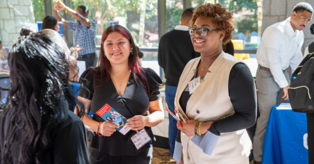 Students smile while at the Career Fair