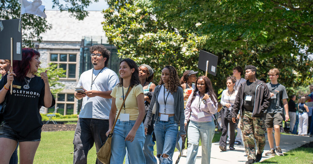 Students follow a guide on a tour of campus.