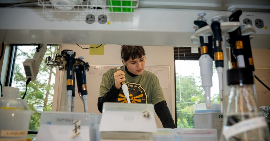 A student uses a micropipette in the lab
