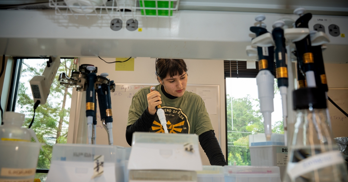 A student uses a micropipette in the lab