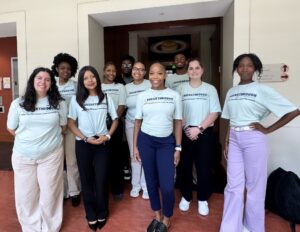 College aged students wearing matching teal shirts that say "Breakthrough Atlanta College Prep 2026 Summer Leadership Institute."