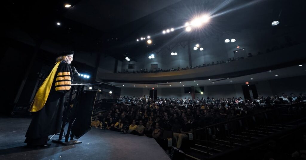 Oglethorpe University President Kathryn McClymond addresses first-year students from the stage at Convocation