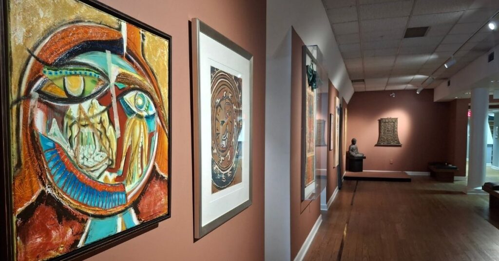 Artwork hangs on the red-brown walls of the newly refurbished Oglethorpe University Museum of Art